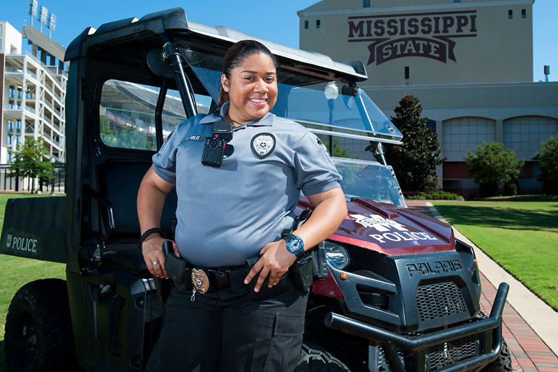 Policewoman standing next to cart